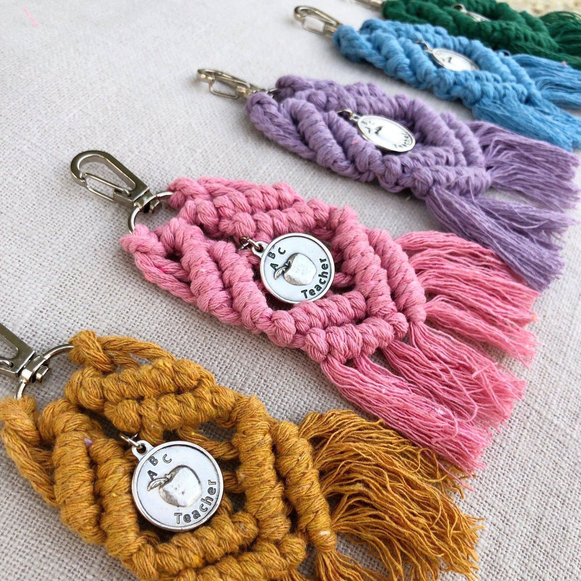 boho macrame keychains in mustard, pink, purple, blue, and green